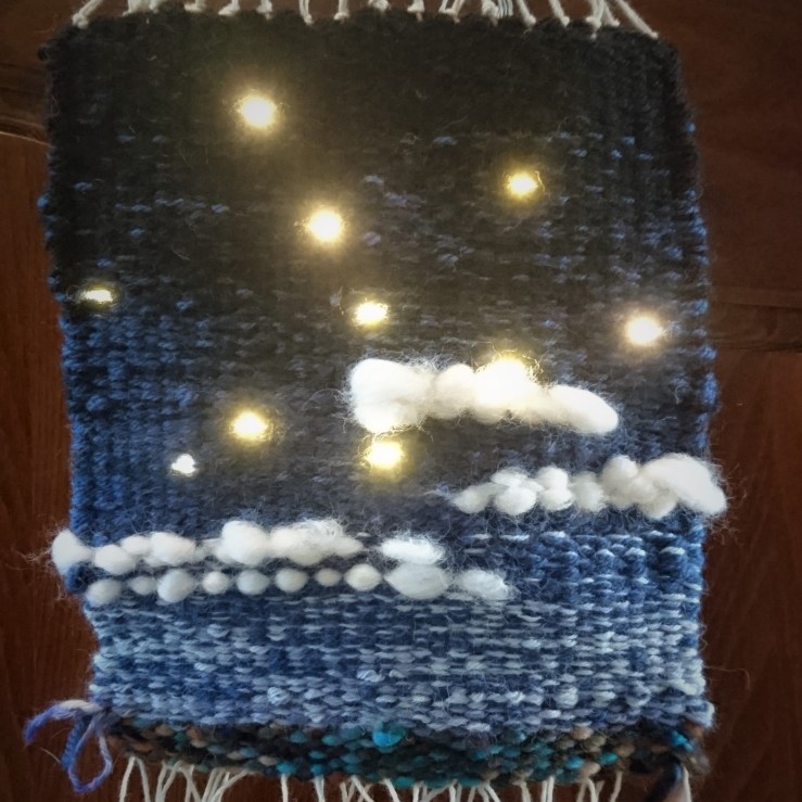 Close up of the sky tapestry, this time with some glowing yellow LED lights in the dark part of the sky.